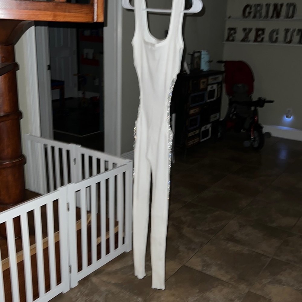 One piece pants romper, ties up on both sides. Fitted, white and sexy size small